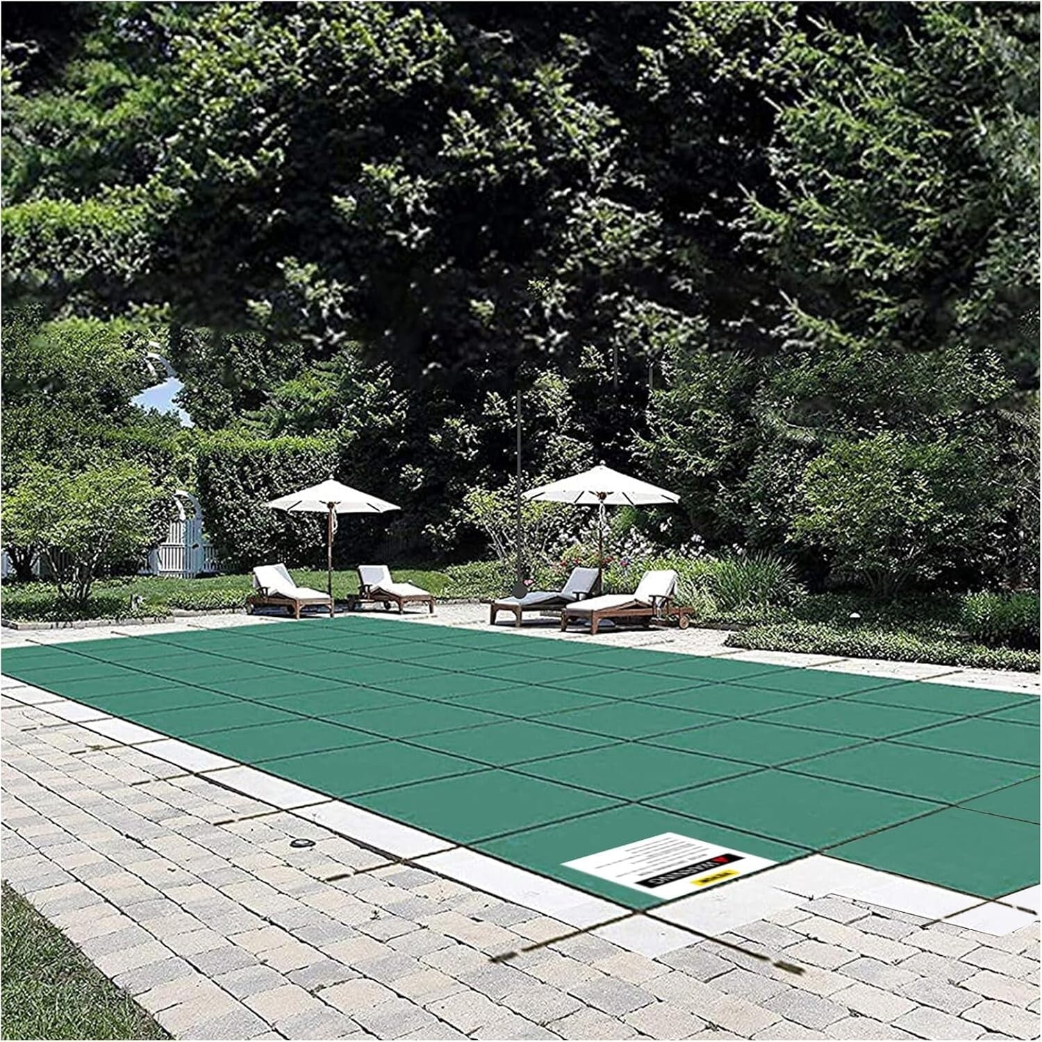 Professional installation of a Loop Loc green mesh safety cover on an inground swimming pool for winter protection and safety.