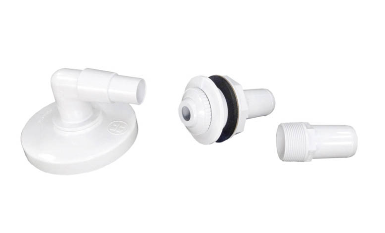 Close-up of the Hayward SP1091WM plumbing accessories: return fitting, hose adapter, and threaded vacuum port plug.