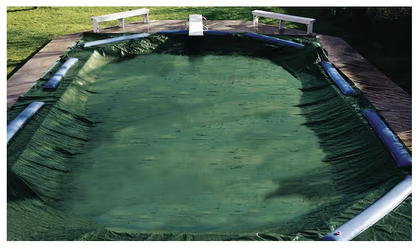 Green Swimline Supreme Guard solid pool cover installed on a rectangular 16x32 inground swimming pool.